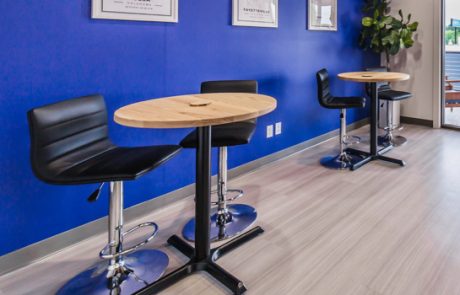 Small round tables with wood tops in an office