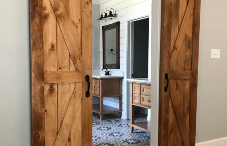 Custom barn doors opening to a bathroom