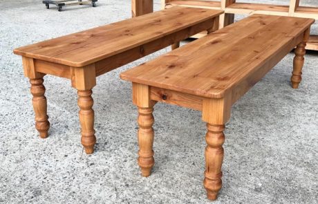 A pair of handmade benches with traditional style legs