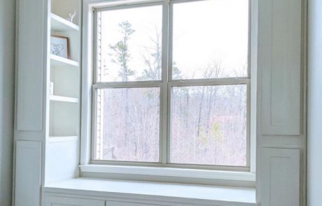 Bright white window seat cabinetry