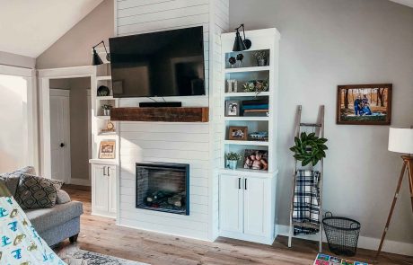 White wood plank living room fireplace with solid wood beam mantle