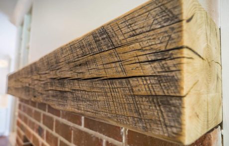 Close up detail of a fireplace mantle wooden beam